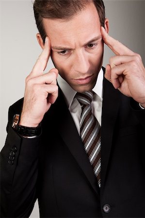 simsearch:693-06967337,k - Young Businessman Is Thinking Hard to Solve Problems Fotografie stock - Microstock e Abbonamento, Codice: 400-04307224