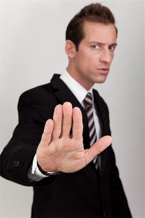 simsearch:400-06635276,k - Business Man Making Stop Sign - focus on hand Photographie de stock - Aubaine LD & Abonnement, Code: 400-04307238