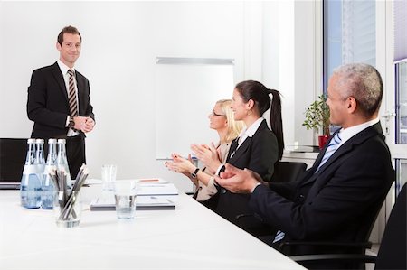 professionals whiteboard - Business team applauding after successful presentation at the meeting Stock Photo - Budget Royalty-Free & Subscription, Code: 400-04307274