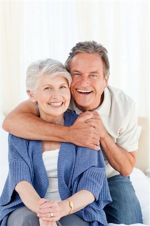 simsearch:400-05711437,k - Senior couple hugging on their bed at home Stock Photo - Budget Royalty-Free & Subscription, Code: 400-04307865