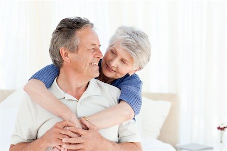 simsearch:400-05711437,k - Senior couple hugging on their bed at home Stock Photo - Budget Royalty-Free & Subscription, Code: 400-04307869