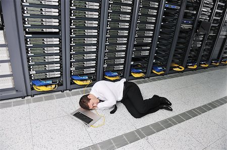 server room managers - young it  engeneer business man with thin modern aluminium laptop in network server room Stock Photo - Budget Royalty-Free & Subscription, Code: 400-04308455