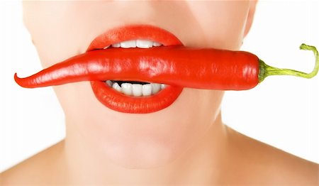 simsearch:400-07899696,k - red chilli pepper at woman mouth on a white Photographie de stock - Aubaine LD & Abonnement, Code: 400-04308544