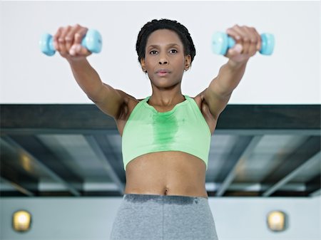 young african american woman in green sportswear doing weight lifting in fitness club. Horizontal shape, front view, waist up Stock Photo - Budget Royalty-Free & Subscription, Code: 400-04308628