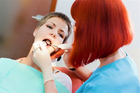 simsearch:400-04309650,k - Image of young lady with dentist over her checking oral cavity Stock Photo - Budget Royalty-Free & Subscription, Code: 400-04308648