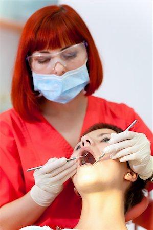 simsearch:400-04309650,k - Image of young lady with dentist over her checking oral cavity Stock Photo - Budget Royalty-Free & Subscription, Code: 400-04308649