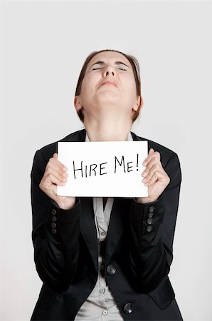 simsearch:400-04648812,k - Business woman holding a card board with the text message "Hire me" Stock Photo - Budget Royalty-Free & Subscription, Code: 400-04309530