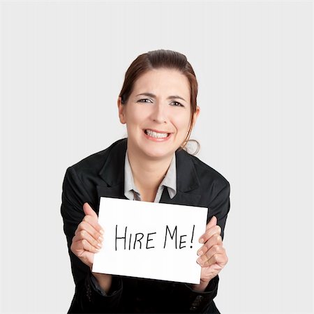 simsearch:400-04648812,k - Business woman holding a card board with the text message "Hire me" and beging for a job. Stock Photo - Budget Royalty-Free & Subscription, Code: 400-04309532
