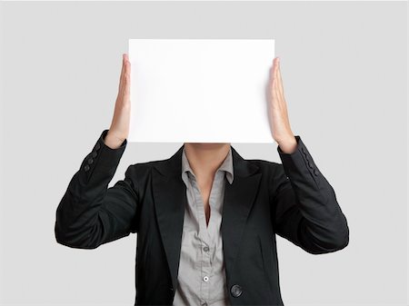 simsearch:400-05718227,k - Woman showing a blank paper sheet in front of her head Stock Photo - Budget Royalty-Free & Subscription, Code: 400-04309546