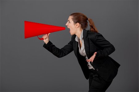 simsearch:400-09223567,k - Business young woman speaking to a megaphone, over a grey background Stock Photo - Budget Royalty-Free & Subscription, Code: 400-04309551