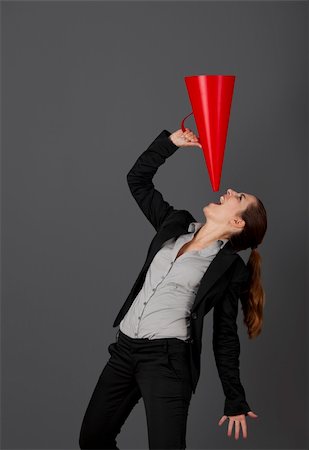 Business young woman speaking to a megaphone, over a grey background Stock Photo - Budget Royalty-Free & Subscription, Code: 400-04309552