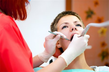 simsearch:400-04340930,k - Image of young lady with dentist over her checking oral cavity Foto de stock - Super Valor sin royalties y Suscripción, Código: 400-04309646