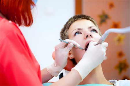 simsearch:400-04340930,k - Image of young lady with dentist over her checking oral cavity Foto de stock - Super Valor sin royalties y Suscripción, Código: 400-04309647