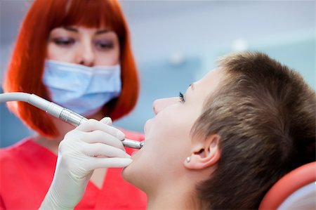 simsearch:400-08109752,k - Image of young lady with dentist over her checking oral cavity Stock Photo - Budget Royalty-Free & Subscription, Code: 400-04309649