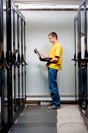 The engineer stand in datacenter near telecomunication equipment Stock Photo - Budget Royalty-Free & Subscription, Code: 400-04309742