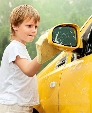 Little boy washing yellow car. Summer. Sunset Fotografie stock - Microstock e Abbonamento, Codice: 400-04309861