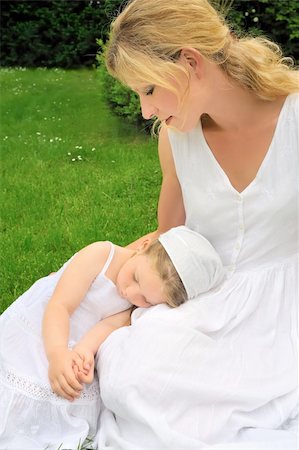 Young mother and daughter resting in meadow Stock Photo - Budget Royalty-Free & Subscription, Code: 400-04300210