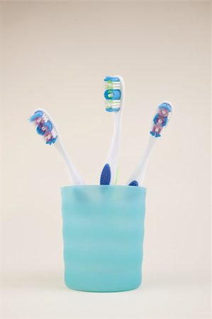 colorful toothbrushes in a blue glass Stock Photo - Budget Royalty-Free & Subscription, Code: 400-04300593