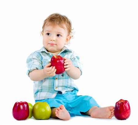 Beautiful baby boy eats red apple. Closeup portrait.  Isolated. Fotografie stock - Microstock e Abbonamento, Codice: 400-04300609