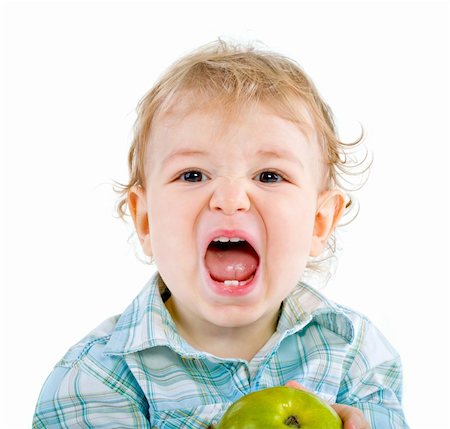 Beautiful baby boy eats green apple. Closeup portrait.  Isolated. Fotografie stock - Microstock e Abbonamento, Codice: 400-04300631