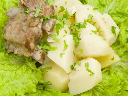 frame is filled by boiled potatoes with bit of meat, which is found on sheet of the green salad Stockbilder - Microstock & Abonnement, Bildnummer: 400-04300821