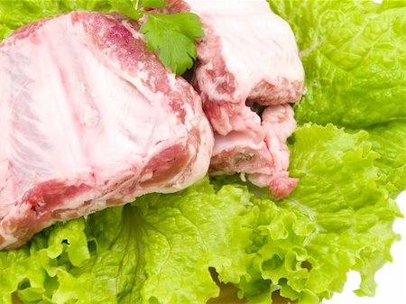 several damp pigs of the bones with meat are found on sheet of the green salad Stock Photo - Budget Royalty-Free & Subscription, Code: 400-04300831