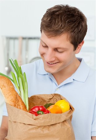 simsearch:400-05072969,k - Man with shoping bags in the kitchen at home Stock Photo - Budget Royalty-Free & Subscription, Code: 400-04300890