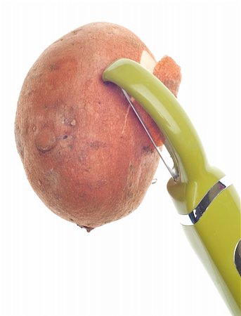 simsearch:400-04300920,k - Sweet Potato Being Peeled with Green Vegetable Peeler. Photographie de stock - Aubaine LD & Abonnement, Code: 400-04300937