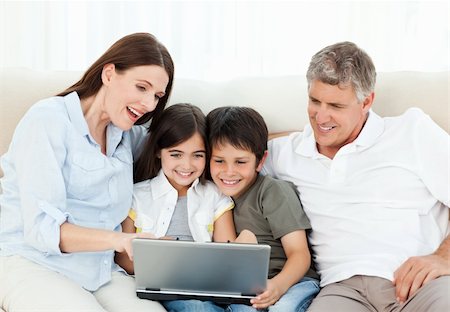 simsearch:400-04044108,k - Family looking at  the laptop at home Stock Photo - Budget Royalty-Free & Subscription, Code: 400-04300956