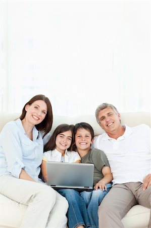 simsearch:400-04044108,k - Pretty family looking at the camera at home Stock Photo - Budget Royalty-Free & Subscription, Code: 400-04300957