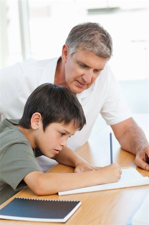Father helping his son with his homework Foto de stock - Royalty-Free Super Valor e Assinatura, Número: 400-04300951