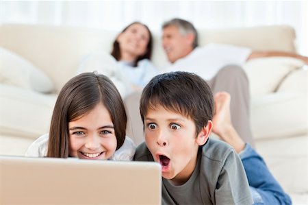 simsearch:400-04044108,k - Lovely children watching a movie on their laptop at home Stock Photo - Budget Royalty-Free & Subscription, Code: 400-04300960