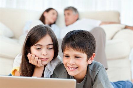 simsearch:400-04044108,k - Lovely children watching a movie on their laptop at home Stock Photo - Budget Royalty-Free & Subscription, Code: 400-04300961