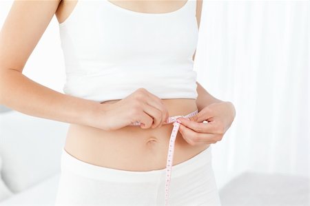 digestion female - Woman looking at  her waistline Foto de stock - Super Valor sin royalties y Suscripción, Código: 400-04301919