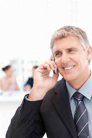 simsearch:400-04113098,k - Businessman phoning  while his team is working in the background Stock Photo - Budget Royalty-Free & Subscription, Code: 400-04301925