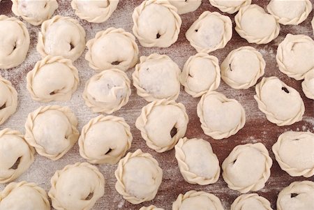 simsearch:622-06163876,k - Russian pelmeni crude on a board sprinkled with a flour Stock Photo - Budget Royalty-Free & Subscription, Code: 400-04302092