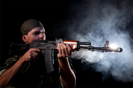 simsearch:400-07257066,k - Soldier with rifle, focus on weapon, smoke on background Stock Photo - Budget Royalty-Free & Subscription, Code: 400-04302179