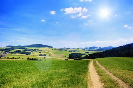 Road in an Austrian Landscape with Sun Stockbilder - Microstock & Abonnement, Bildnummer: 400-04302435