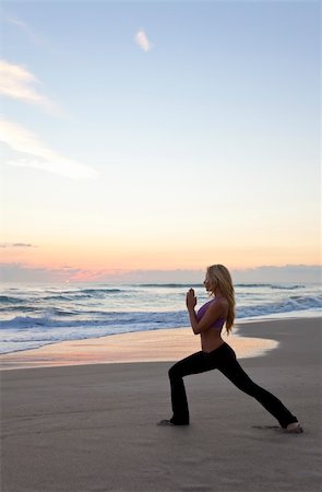 Beautiful young woman practicing yoga on a beach at sunrise or sunset Stock Photo - Budget Royalty-Free & Subscription, Code: 400-04302451