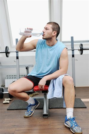 satisfied (thirst) - young man drink water at fitness workout training at sport club Foto de stock - Super Valor sin royalties y Suscripción, Código: 400-04303135