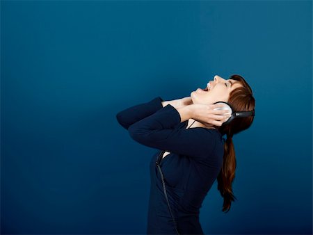 portrait screaming girl - Happy young woman singing and listen music with headphones Stock Photo - Budget Royalty-Free & Subscription, Code: 400-04303333