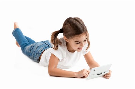 Little girl lying on floor playing a video-game Stock Photo - Budget Royalty-Free & Subscription, Code: 400-04303397
