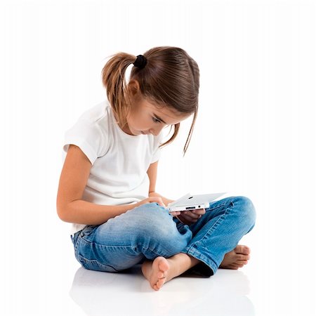 Little girl sitting on floor playing a video-game Stock Photo - Budget Royalty-Free & Subscription, Code: 400-04303399