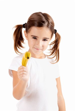 Little girl isolated on white pretending is shoot with a banana Photographie de stock - Aubaine LD & Abonnement, Code: 400-04303420