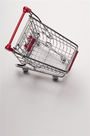 simsearch:400-08899989,k - Empty shopping cart with the red handle on a white background. Stockbilder - Microstock & Abonnement, Bildnummer: 400-04314156