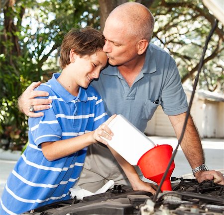 Loving father kisses his son as they work on the car engine together. Stock Photo - Budget Royalty-Free & Subscription, Code: 400-04314167