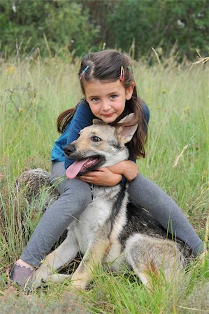 slovakia people - little girl and her baby purebred wolf dog Stock Photo - Budget Royalty-Free & Subscription, Code: 400-04314201