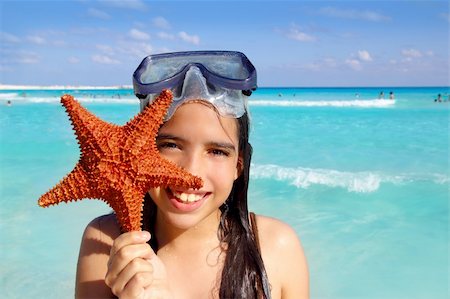latin tourist girl holding starfish in tropical beach Stock Photo - Budget Royalty-Free & Subscription, Code: 400-04315001