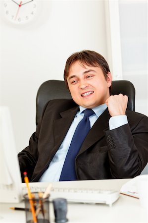 simsearch:400-05900668,k - Successful modern businessman sitting at office desk and looking at computer monitor Stock Photo - Budget Royalty-Free & Subscription, Code: 400-04315466