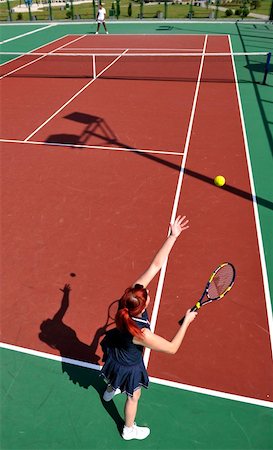 simsearch:400-06061549,k - young fit woman play tennis outdoor on orange tennis field at early morning Photographie de stock - Aubaine LD & Abonnement, Code: 400-04315702